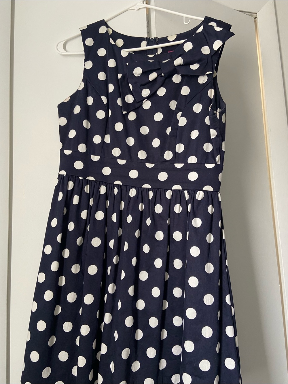 Navy and White Polka Dot Sleeveless Mini Dress with Bow Accent from Modcloth